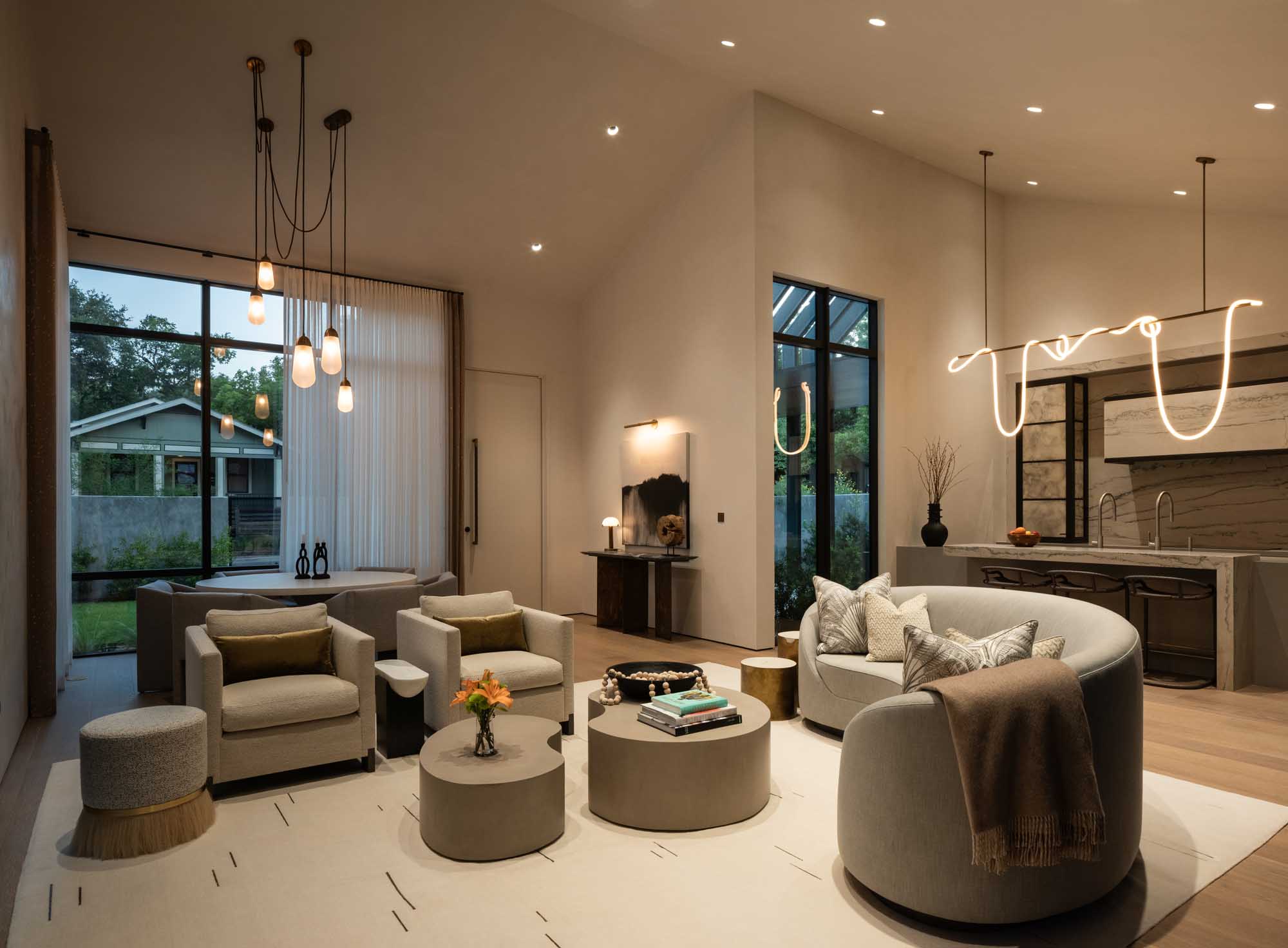 Bright open living room featuring warm Lutron architectural lighting.